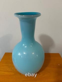 Light blue or turquoise blown glass vase with a globe-shaped base and a narrow n