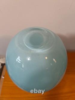 Light blue or turquoise blown glass vase with a globe-shaped base and a narrow n